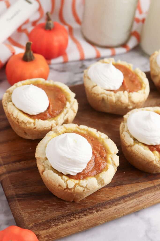 Pumpkin Pie Sugar Cookies on wooden cutting board.