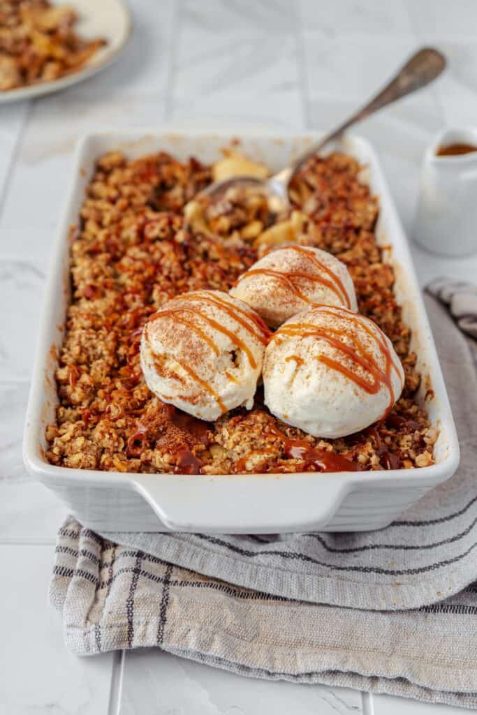 Apple Crisp With Vanilla Ice Cream in baking dish.