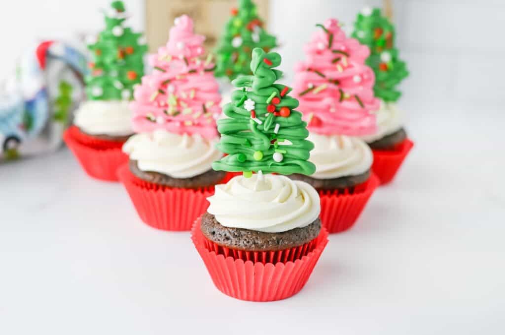 Christmas Tree Cupcakes in a v-formation on kitchen counter.