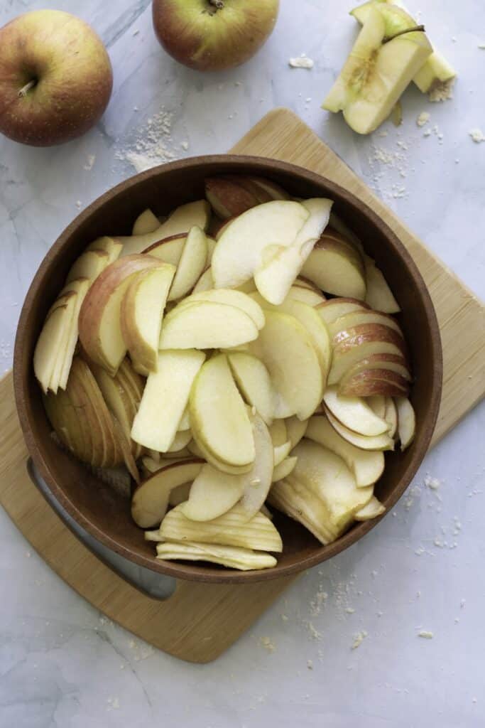 Double-Crust Honeycrisp Apple Pie, in process, sliced apples in bowl.