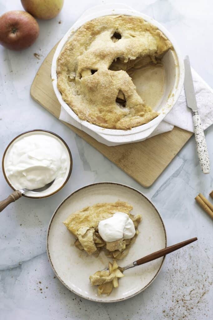 Piece of double-Crust Honeycrisp Apple Pie next to entire pie.