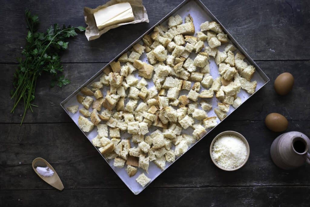 Homemade Herb and Vegetable Stuffing, in process, bread cubes in pan, ready to bake.