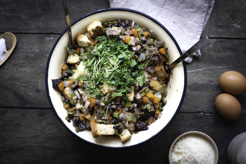 Homemade Herb and Vegetable Stuffing, in process, herbs, mushrooms and vegetables in bowl.