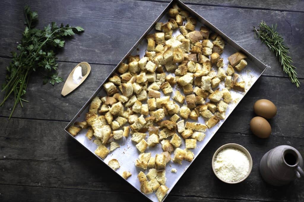 Homemade Herb and Vegetable Stuffing, in process, toasted bread cubes in pan.