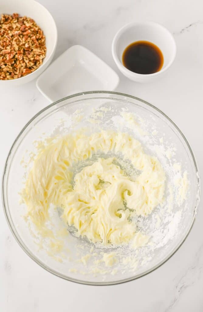 Pecan Snowball Cookies, in process, whipped powdered sugar and butter in mixing bowl.