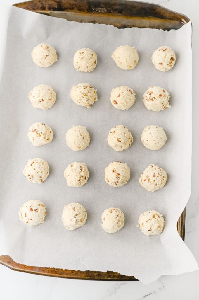 Pecan Snowball Cookies, in process, ready-to-bake cookies on baking tray.
