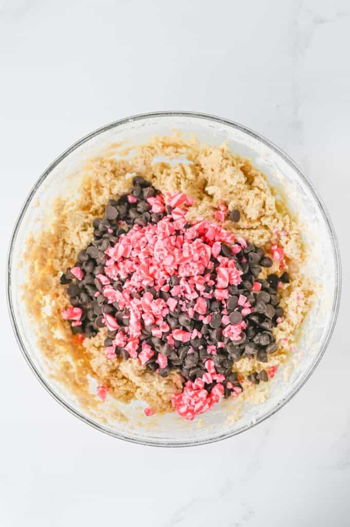 Peppermint Chocolate Chip Cookies, in process, chocolate chips and crushed candy canes added to batter.