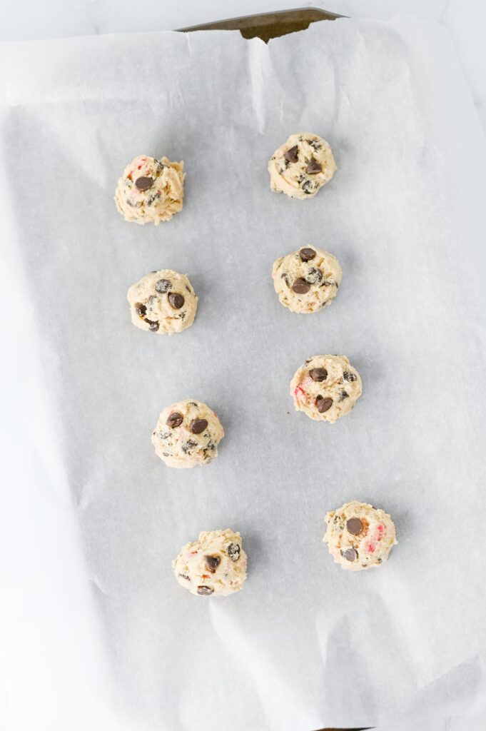 Peppermint Chocolate Chip Cookies, in process, ready to bake on lined baking tray.