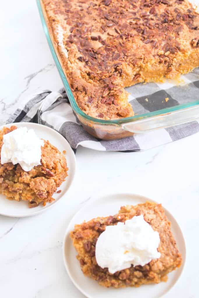 Pumpkin Crunch Cake piece on plates and in serving dish.