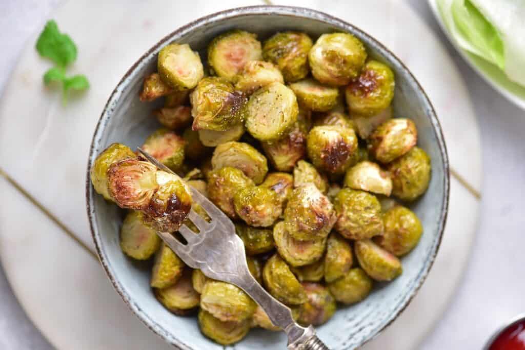 Easy Roasted Brussels Sprouts in bowl with fork.